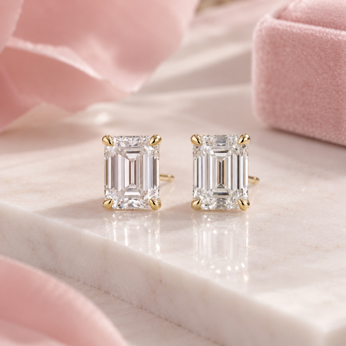 Emerald-cut diamond stud earrings in gold prong settings